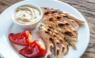Grilled chicken with stuffed peppers and tahini sauce photo