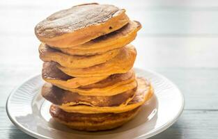 Stack of pumpkin pancakes on the plate photo