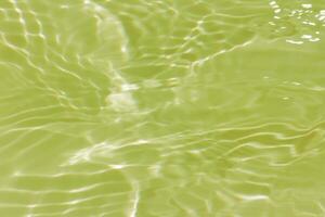 Defocus blurred transparent blue colored clear calm water surface texture with splashes reflection. Trendy abstract nature background. Water waves in sunlight with copy space. Blue watercolor shine. photo