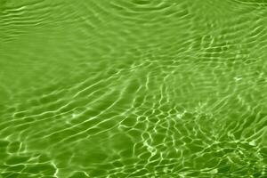 Defocus blurred transparent blue colored clear calm water surface texture with splashes reflection. Trendy abstract nature background. Water waves in sunlight with copy space. Blue watercolor shine. photo
