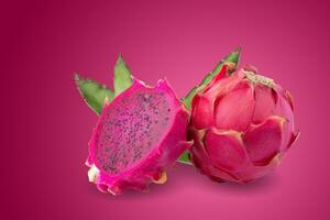 Ripe pitahaya fruit or dragon fruit with half isolated on red background photo