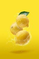 Creative layout made from lemon fruit and leaves isolated on yellow background, in water splashing. photo