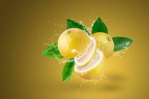 water splash on yellow lemon isolated on a yellow background. photo