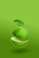 Creative layout made from green lime fruit and leaves isolated on green background photo