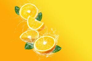 Creative layout made from Fresh Sliced oranges and Orange fruit and water Splashing on a pink background. photo