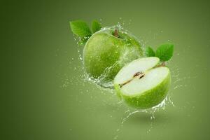Creative layout made form whole and slice green apple and water splashing on a green background. photo