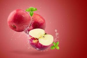 Creative layout made from Fresh Red Apple fruit  and water Splashing on a red background. photo