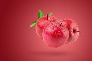 Fresh red apple isolated on a red background. photo