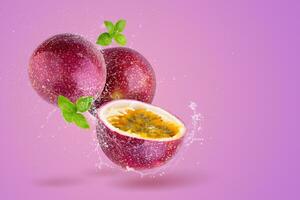 Creative layout made from Fresh passionfruit  and water Splashing on a pink background. photo