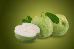 Green guava and half and leaves on a green background photo