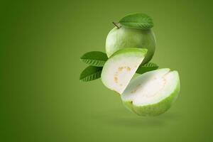 Creative layout made form whole and slice of Guava fruit and leaves on a green background. photo