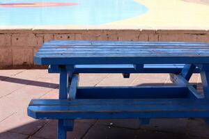 Bench for rest in a city park on the shores of the Mediterranean Sea. photo