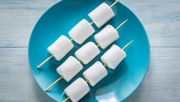 Marshmallow skewers on the plate photo