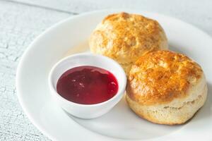 Classic scones with cream and berry jam photo