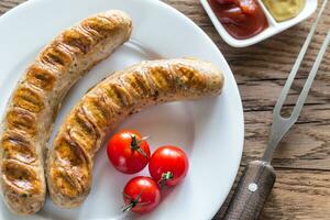 Grilled sausages with tomato and mustard sauce photo