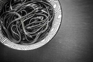 Bowl of black pasta photo