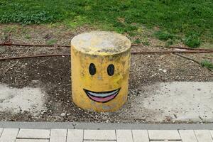 A row of pillars along the road for the safe passage of pedestrians along the sidewalk. photo