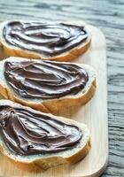 Slices of baguette with chocolate cream photo