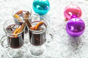 Glasses of mulled wine in snow photo