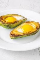 Baked eggs in avocado photo