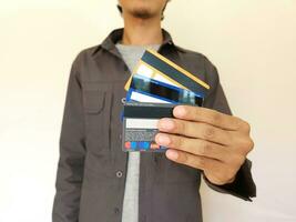 man showing multiple indonesia banking cards photo