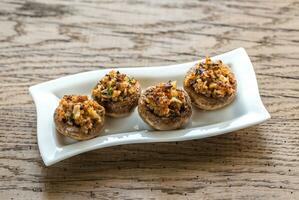 Mushrooms' caps stuffed with mixture of cheese, onion, breadcrum photo