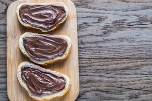 Slices of baguette with chocolate cream photo