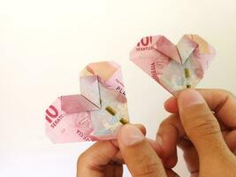 Indonesian rupiah money in heart shaped. illustration for split bill with partner photo