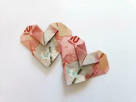Indonesian rupiah money in heart shaped. illustration for split bill with partner photo