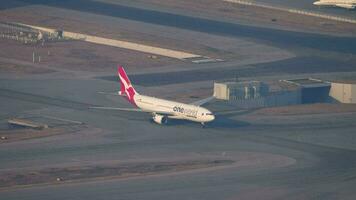 HONG KONG NOVEMBER 09, 2019 - Passenger plane of Qantas taxiing at Hong Kong airport, top view. Qantas Airways Limited is an Australian airline video