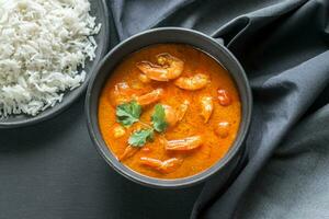 Thai yellow curry with seafood and white rice photo