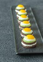 Canape with fried quail eggs photo