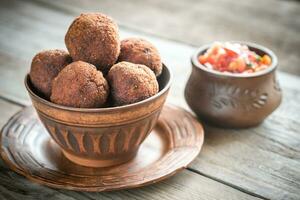 Bowl of meatballs with mexican sauce salsa photo