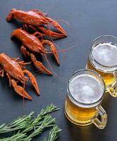 Boiled crayfish with two mugs of beer photo