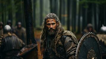 Portrait of a medieval warrior in the forest. Viking. photo