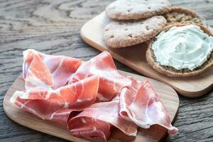 Slices of jamon and sandwich with cream cheese photo