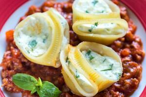Lumaconi stuffed with ricotta with bolognese sauce photo