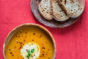 Bowl of spicy pumpkin cream soup photo