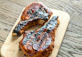 Grilled pork ribs on the wooden board photo