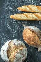 Different kinds of bread on the wooden background photo