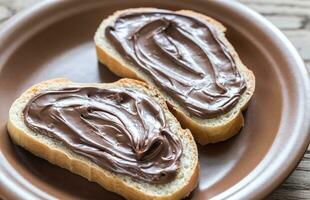 Slices of baguette with chocolate cream photo