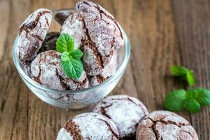 Bowl of chocolate cookies on the wooden background photo