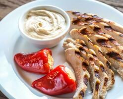 Grilled chicken with stuffed peppers and tahini sauce photo