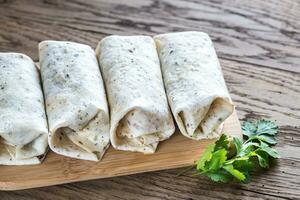 Chicken burritos on the wooden background photo