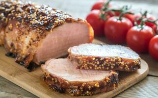Baked pork meat wrapped in bacon photo