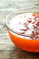 Glass bowl of thai sweet chili sauce photo