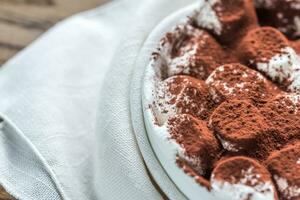 Portion of roasted marshmallows with cocoa powder photo