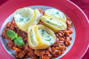 Lumaconi stuffed with ricotta with bolognese sauce photo