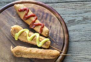 Corn dogs on the wooden board photo