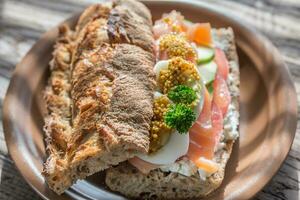 Sandwich with salmon, avocado and eggs photo